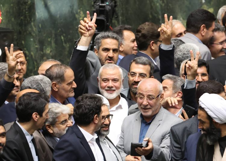 epa11510677 Hamas political leader Ismail Haniyeh (C) flashes victory sign as surrounded by Iranian lawmakers at the Iranian parliament in Tehran, Iran, 30 July 2024 (issued 31 July 2024). According to an Iranian Revolutionary Guard Corps (IRGC) statement on 31 July 2024, Haniyeh and one of his bodyguards were targeted and killed in Tehran on 31 July 2024.  EPA/ABEDIN TAHERKENAREH